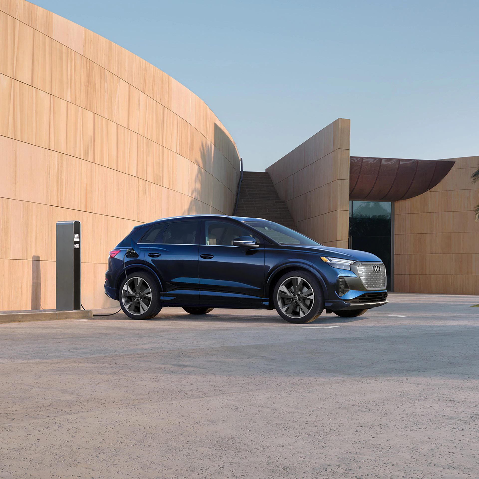 2022 Audi Q4 e-tron Exterior view of a blue Audi Q4 charging outside