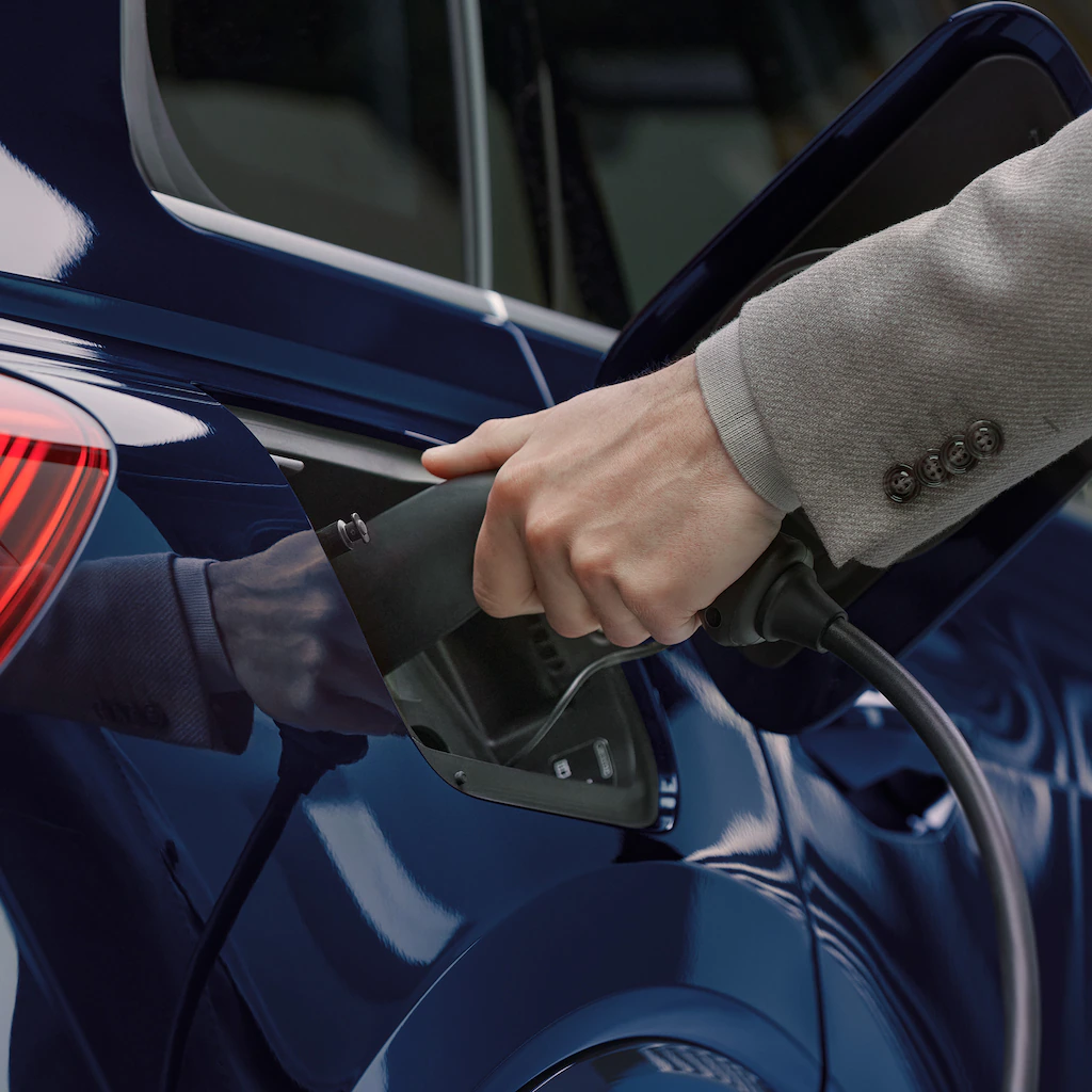 2022 Audi Q4 e-tron A person charging an Audi Q4 e-tron