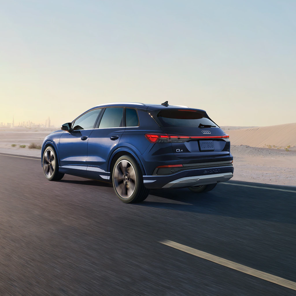 2022 Audi Q4 e-tron Exterior view of a blue Audi Q4 driving outside on a nice day