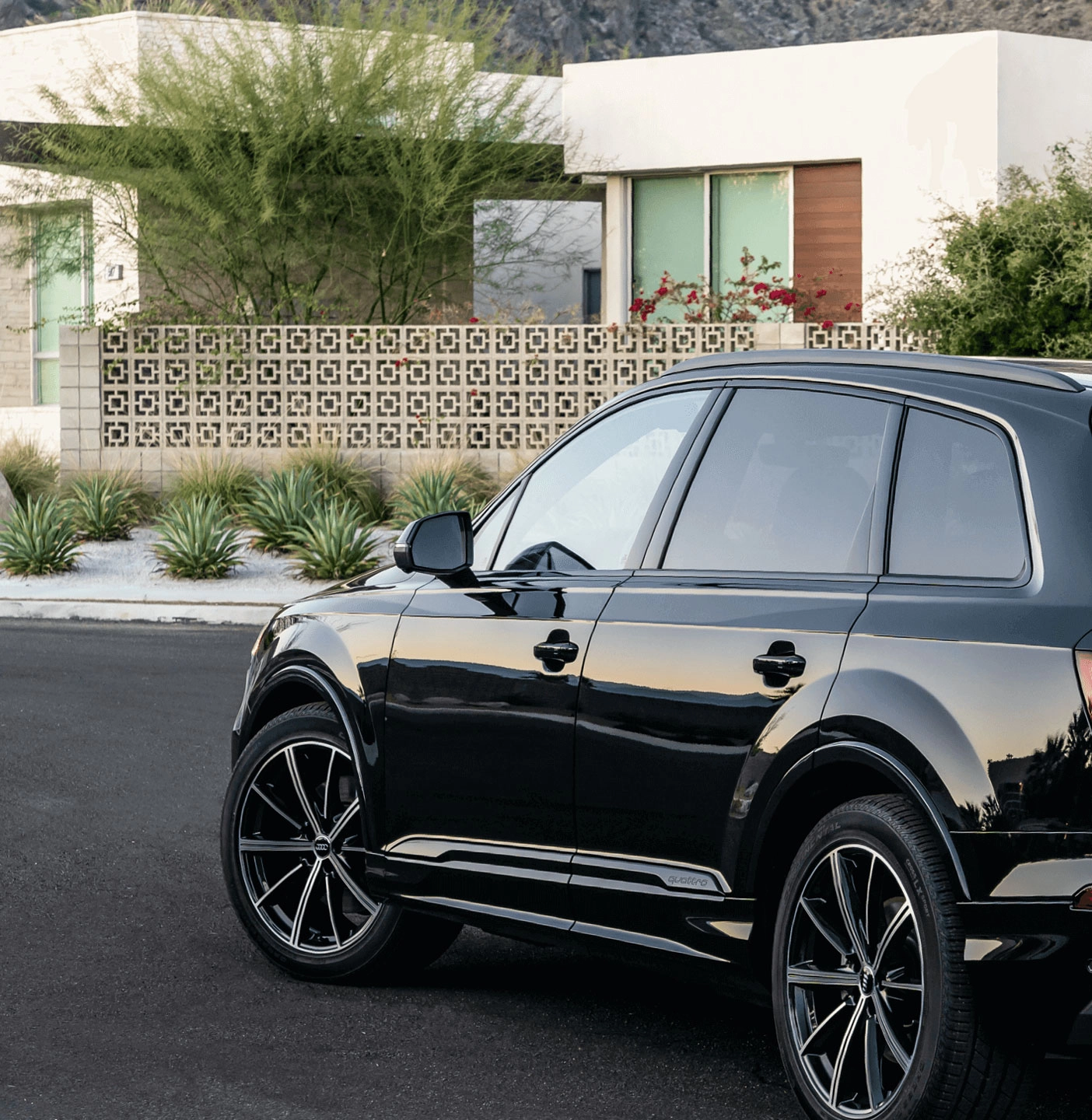 A black Audi Q5 driving down the road