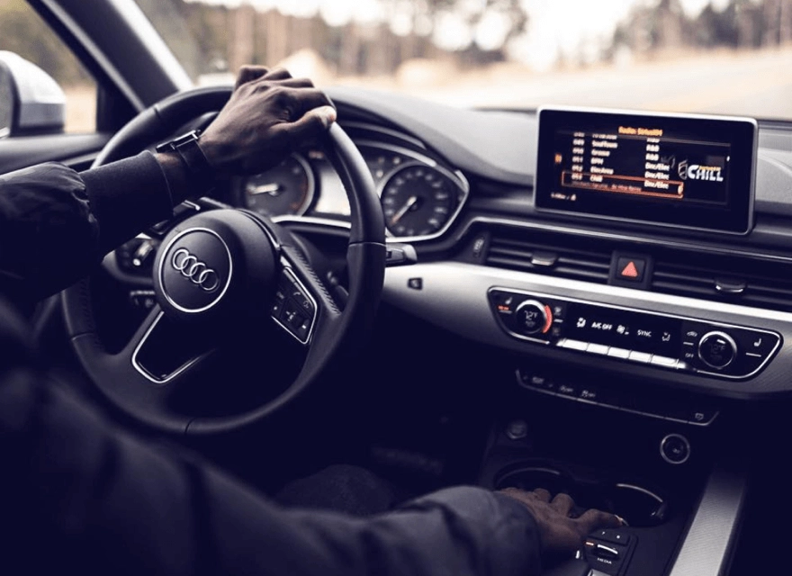 A person driving an Audi listening to SiriusXM Satellite Radio