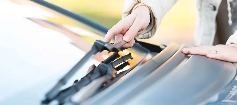 Toyota Wiper Blades at Freeman Toyota Closeup of hand checking wiper blade on vehicle