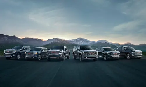 Real Time Used Car Price Policy Lineup of GMC vehicles in front of mountains