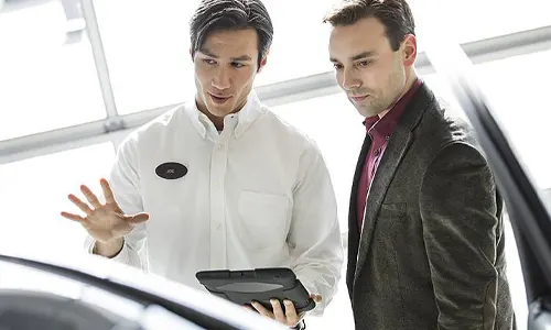 Certified Managers 2 men looking over a vehicle
