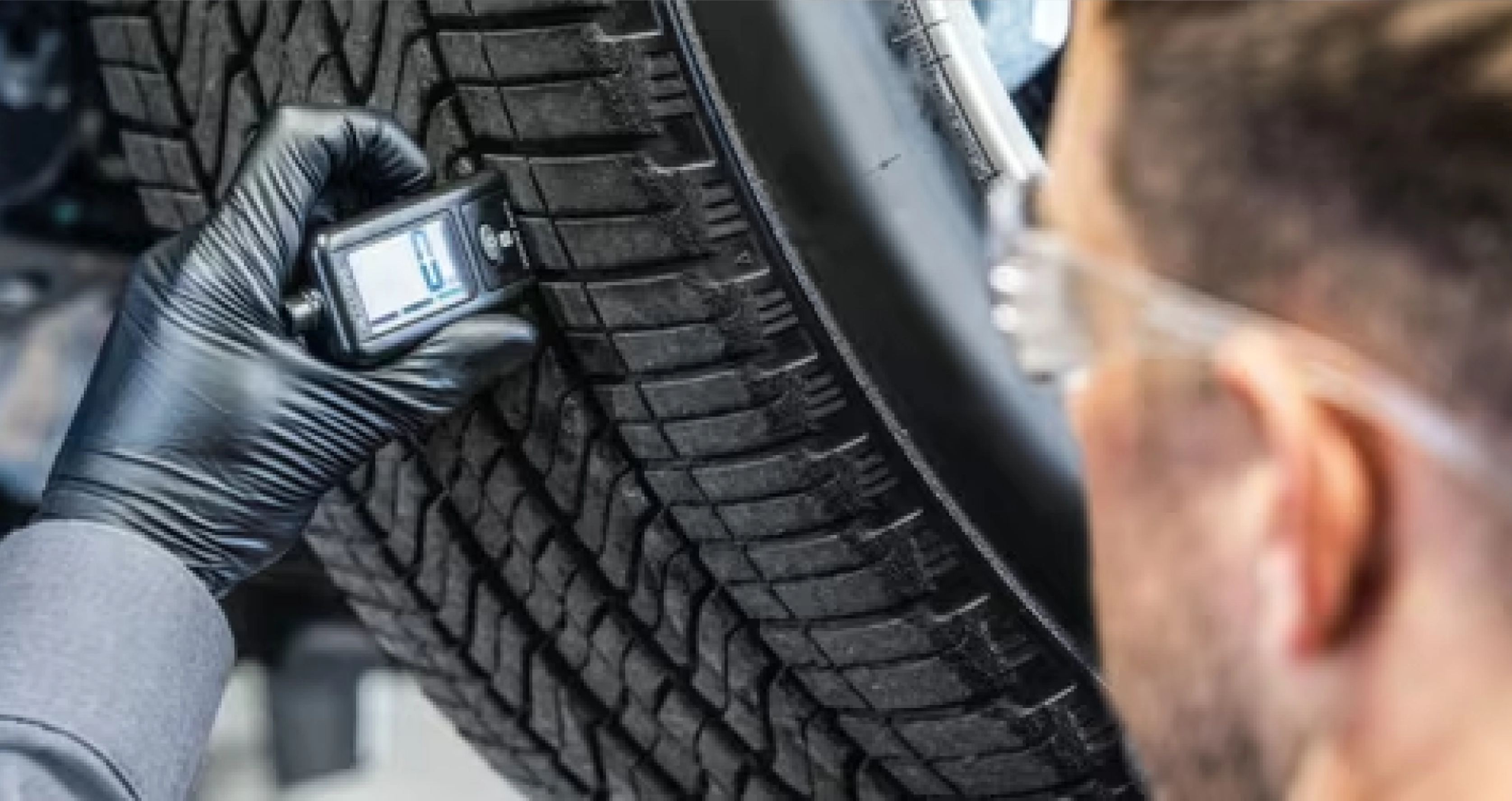 GMC Certified Service Technician testing tire pressure