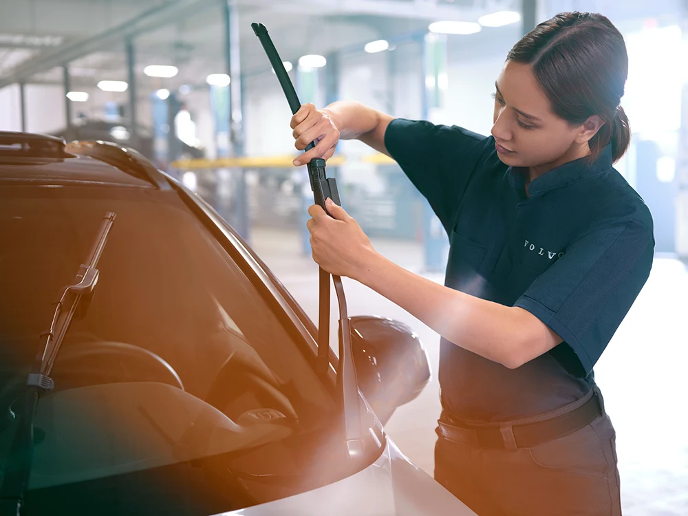 A Volvo technician changing wiper blades