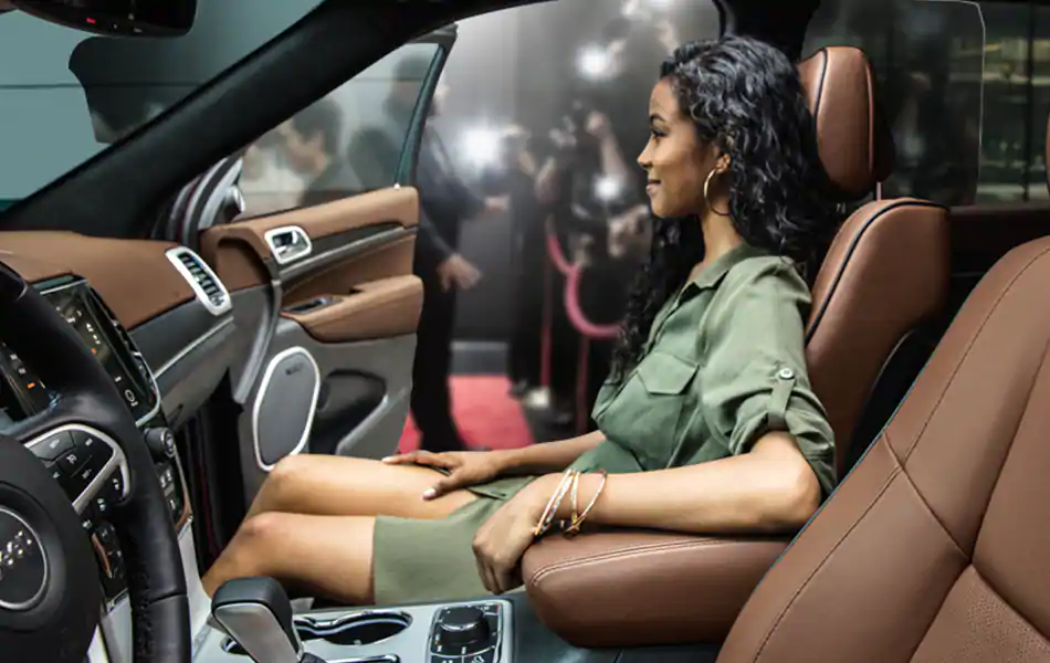 Jeep Wave VIP Treatment An image of a woman in the passenger seat of a Jeep vehicle.