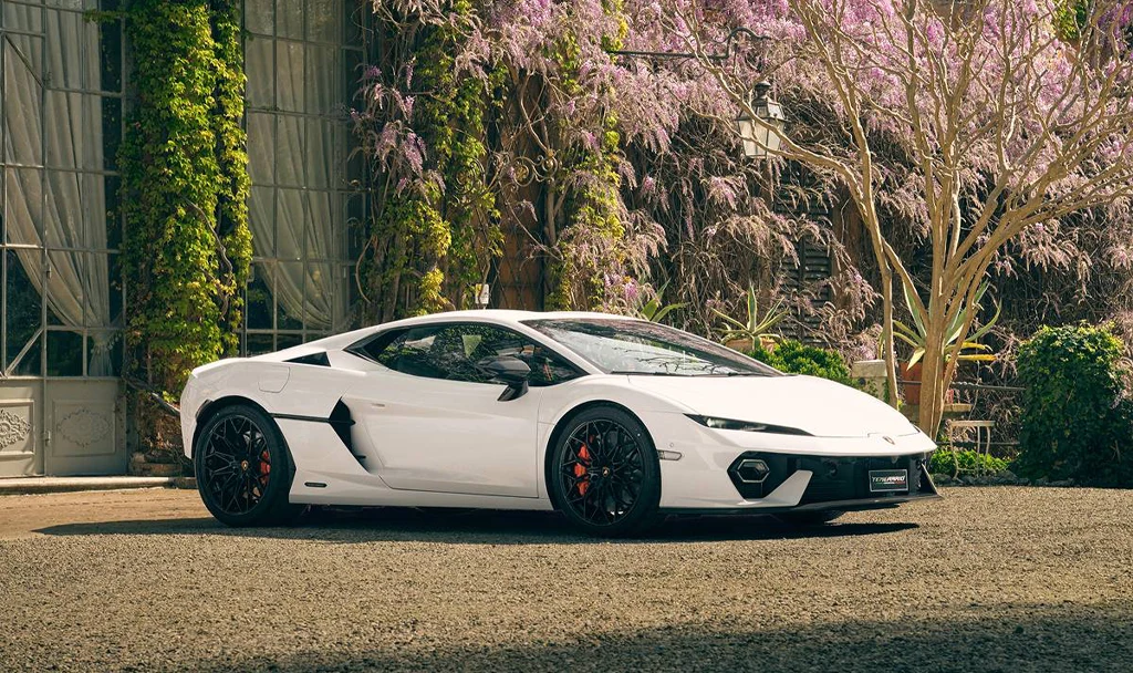 White Lamborghini parked in front of house