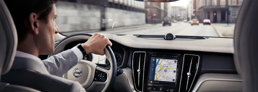 Volvo Lease Ownership Man driving down the road in a 2021 Volvo S60