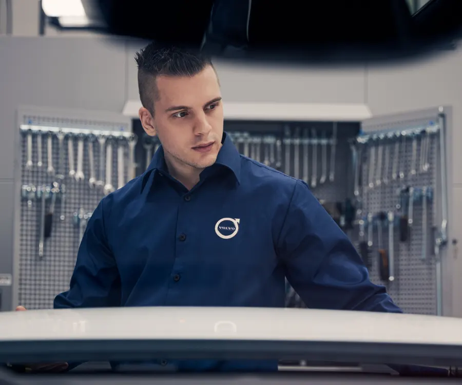 Volvo Automotive Technician looking at vehicle