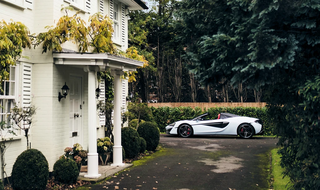 Photo of a McLaren parked in a driveway.