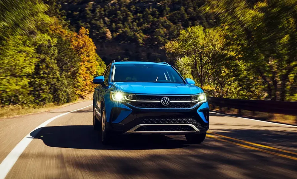 2022 Volkswagen Taos Blue Taos driving on a nice sunny day