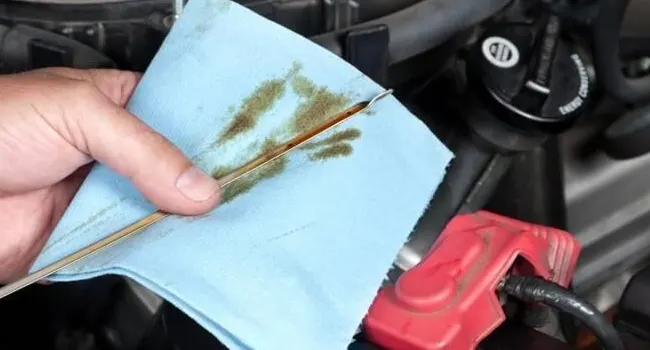 North Shore Nissan Parts Offer - DIY Discount Closeup of hand checking oil dipstick