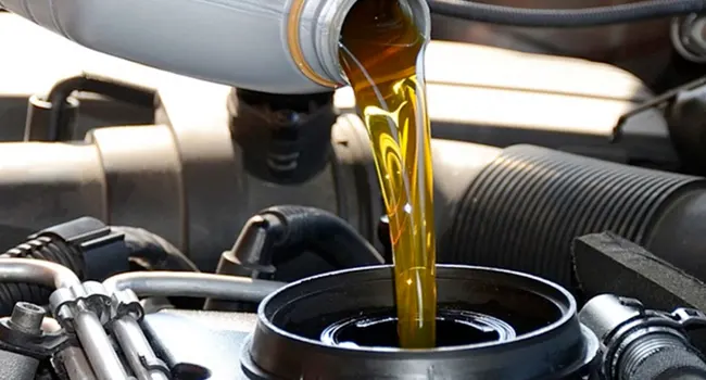 Service Offer - Oil Change & Tire Rotation Special Oil being poured into engine