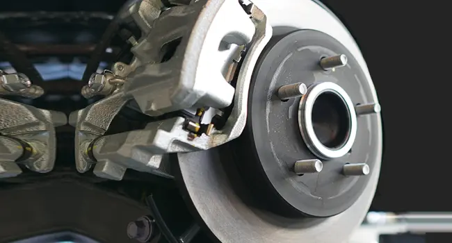 Service Offer - Brake Pad & Rotor Replacement Special Technician rotating a tire