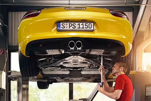 Free Multi-Point Inspection (MPI) A man working on a Porsche in a shop