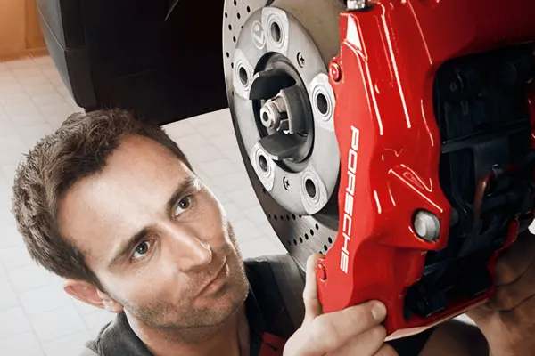 15% Off Brake Service A man working on Porche brakes
