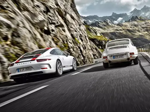 Porsche Approved Certified Pre‑Owned Limited Warranty 2 Porsches driving on a windy mountain road