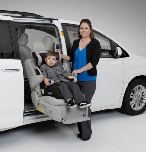 Woman standing next to an Auto Seat in the Toyota Sienna with a little boy