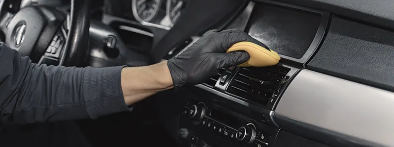 Toyota Full Detailing Special A technician cleaning a car's dashboard