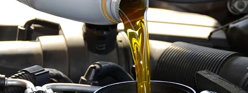 Toyota Winter Special Toyota technician pouring oil into an engine