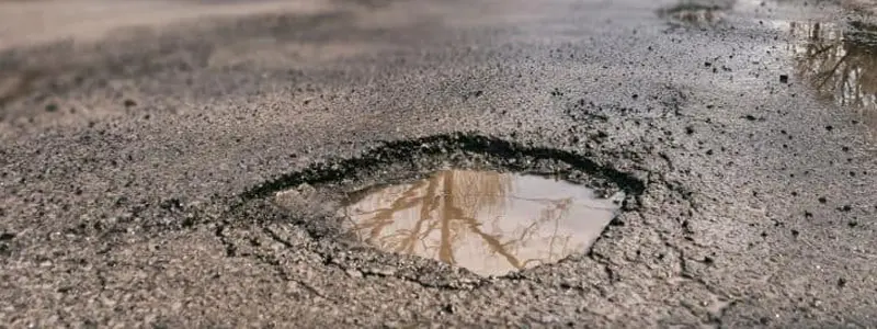 Toyota Pothole Special Pothole in the road filled with rain