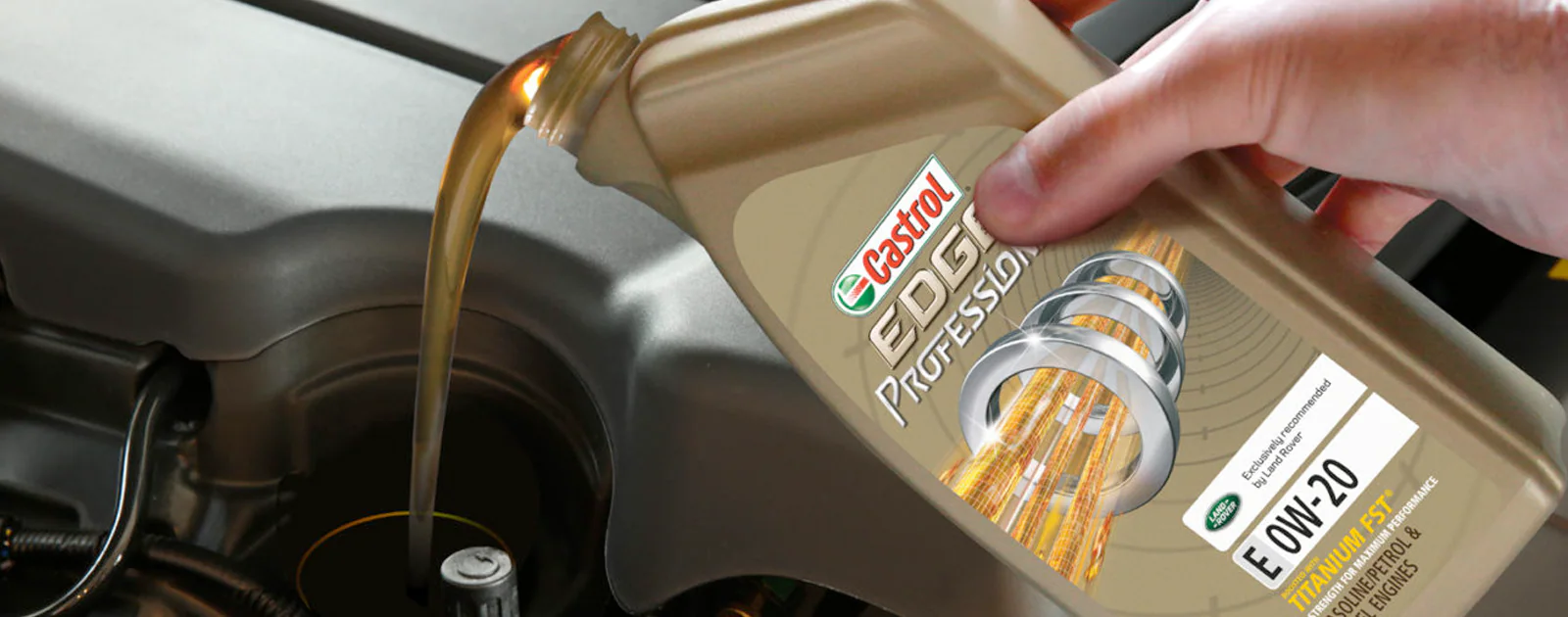 An Expert Partnership A technician pouring Castrol oil into an engine