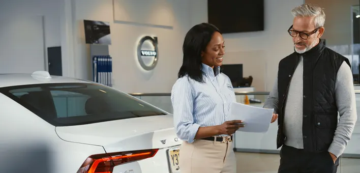 Lifetime Parts & Labor Warranty Customer looking over Contract with a Volvo employee