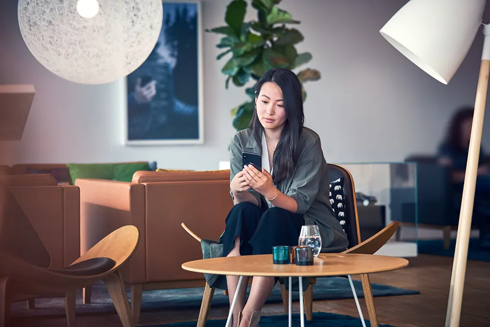 Volvo Orange County Customize Your Deal Girl searching on her phone