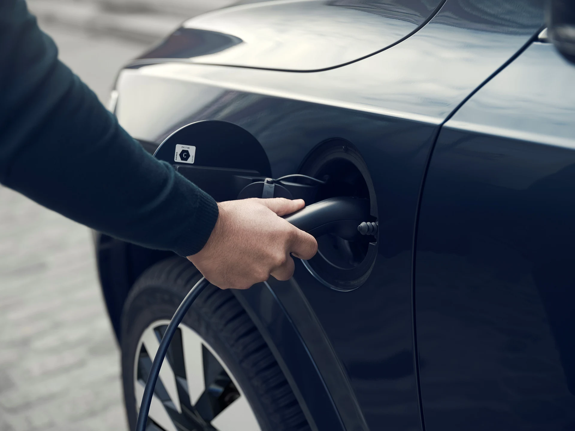 Closeup of a man charging an XC90