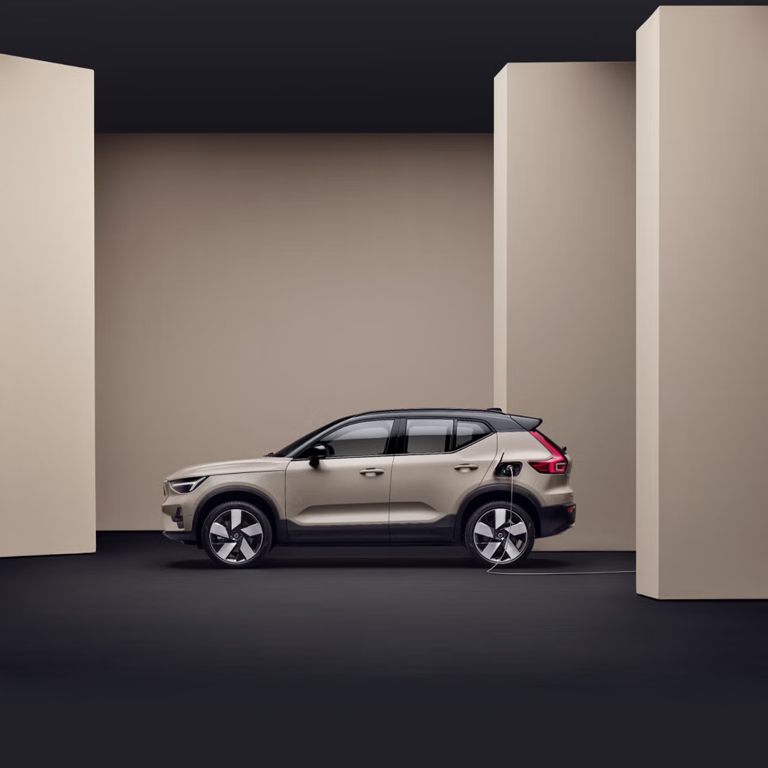 A fully electric Volvo EX40 plugged in to charge.