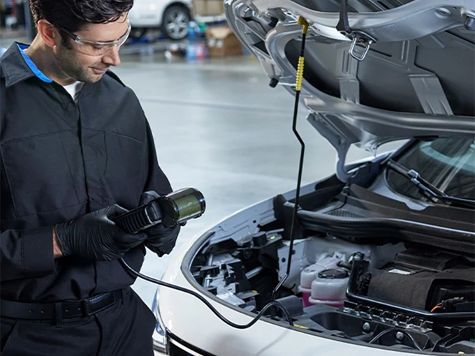 VW service tech inspecting vehicle