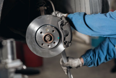 mechanic working on brake assembly