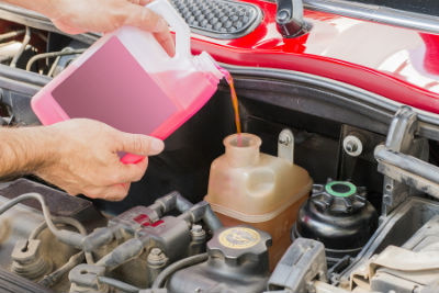 mechanic filling reservoir with coolant