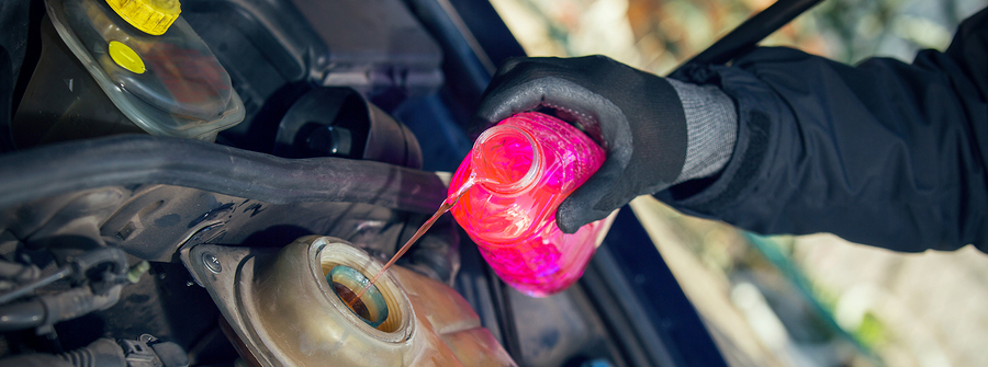 Technician pouring coolant