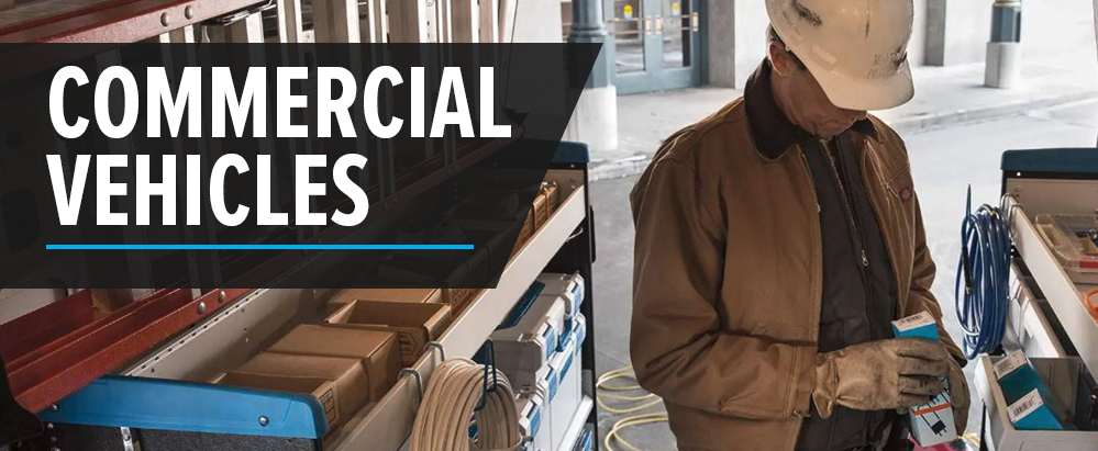 worker examining tools inside working van