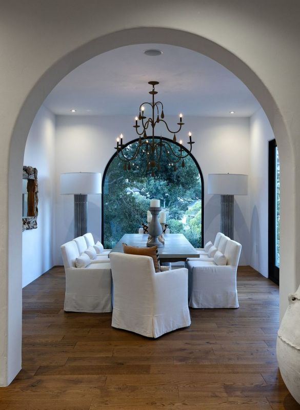 dining room seating under chandelier with large window