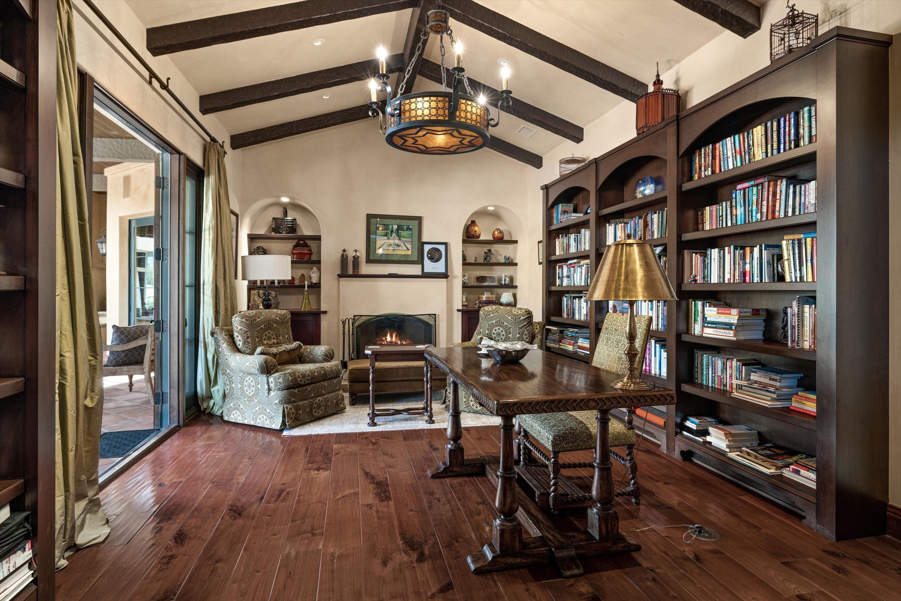 A luxury study with bookshelves and a handsome home office desk