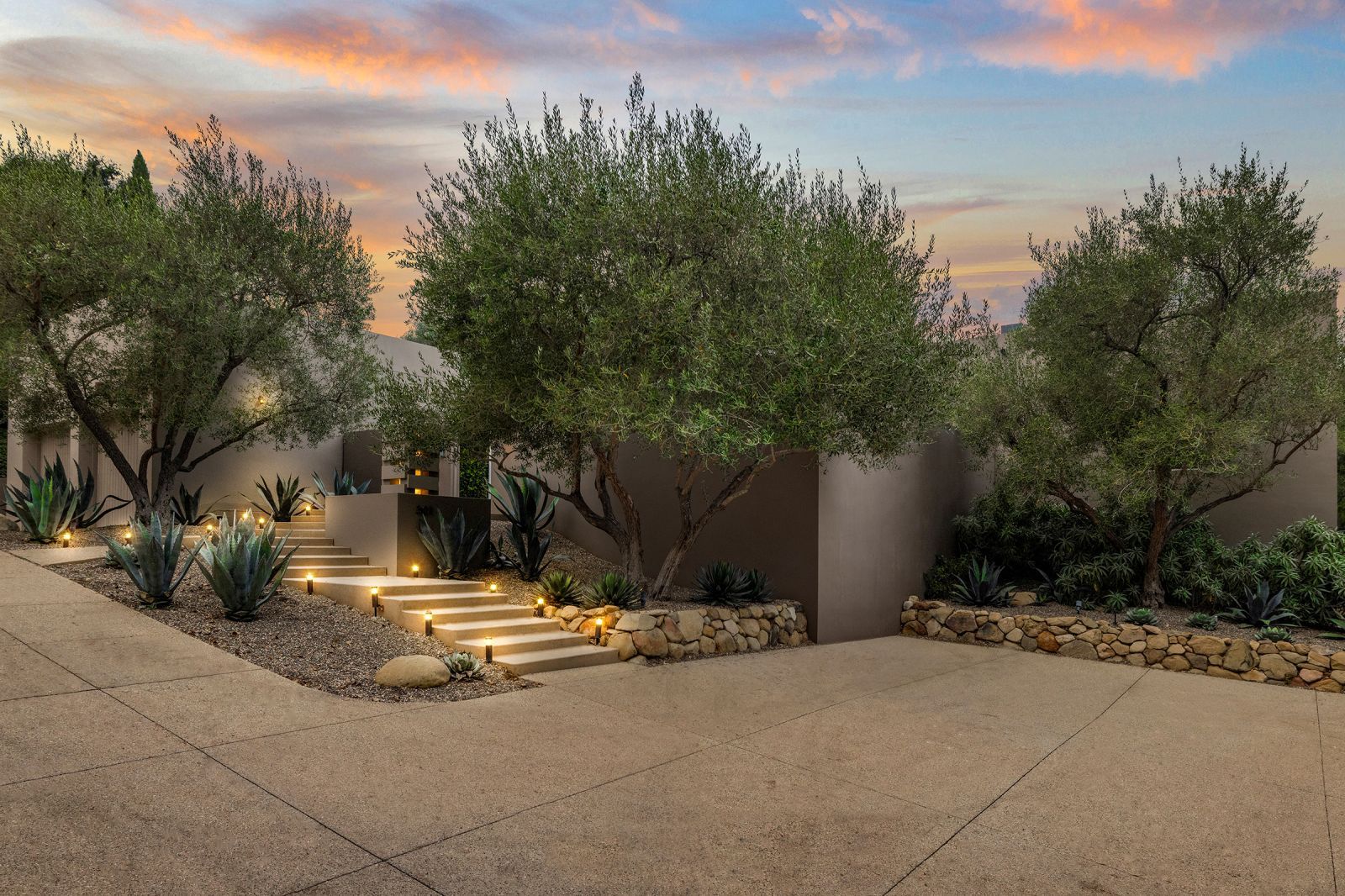 Front stairs and facade of a Montecito Contemporary home at sunset.