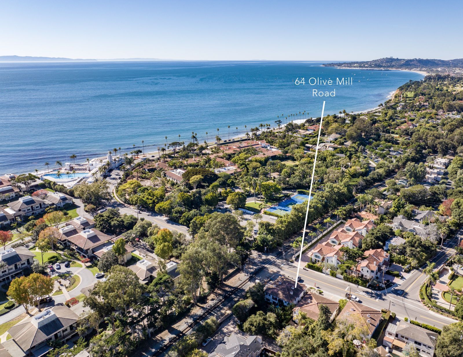 A birds eye view of Montecito with it's beaches in the b and ocean in the background and an arrow pointing out one home in a neighborhood.