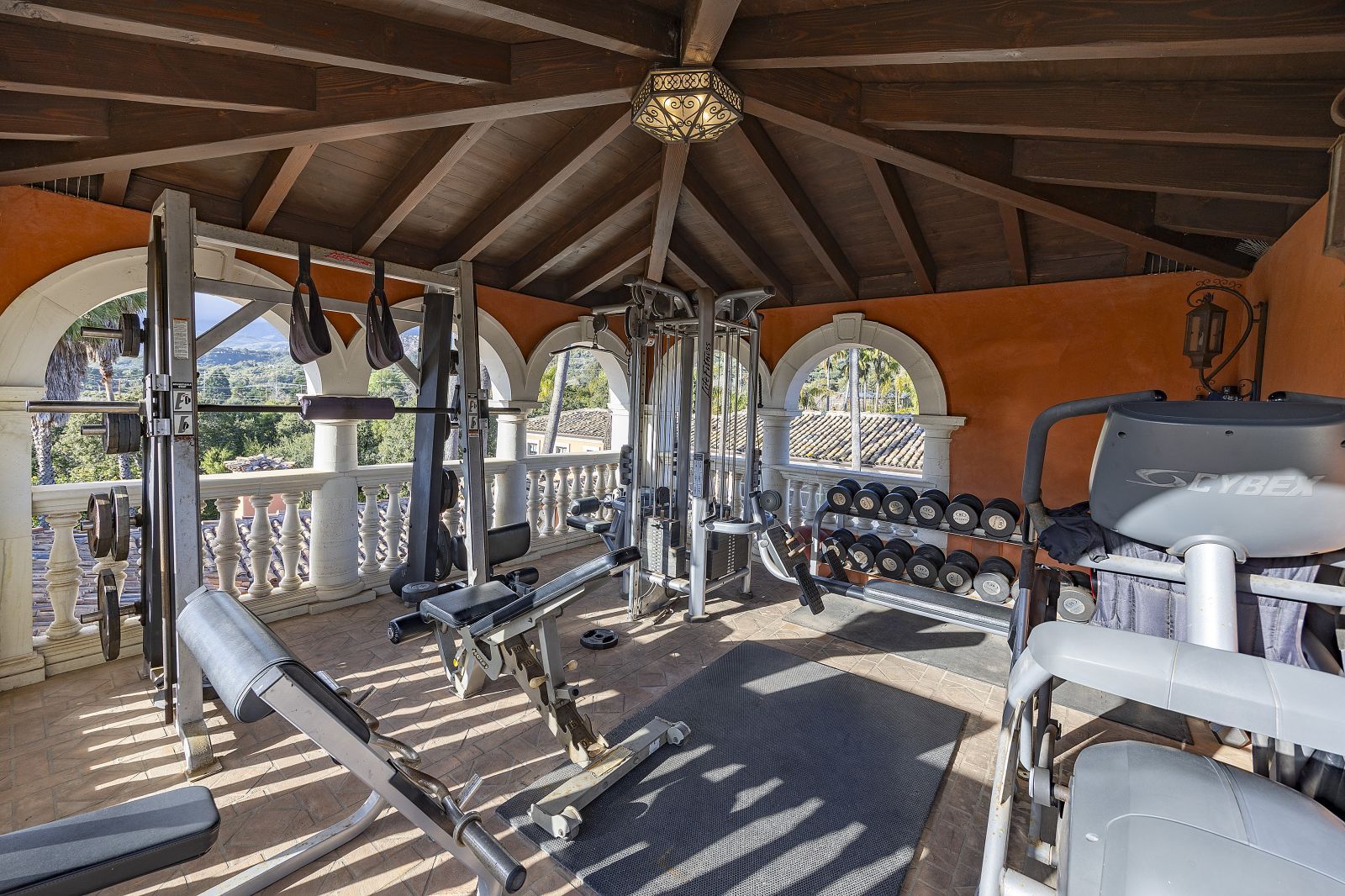 A home gym in an octagonal room filled with state-of-the-art equipment.