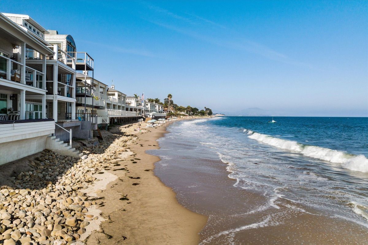 Row of Miramar beach houses just feet from the beach and waves