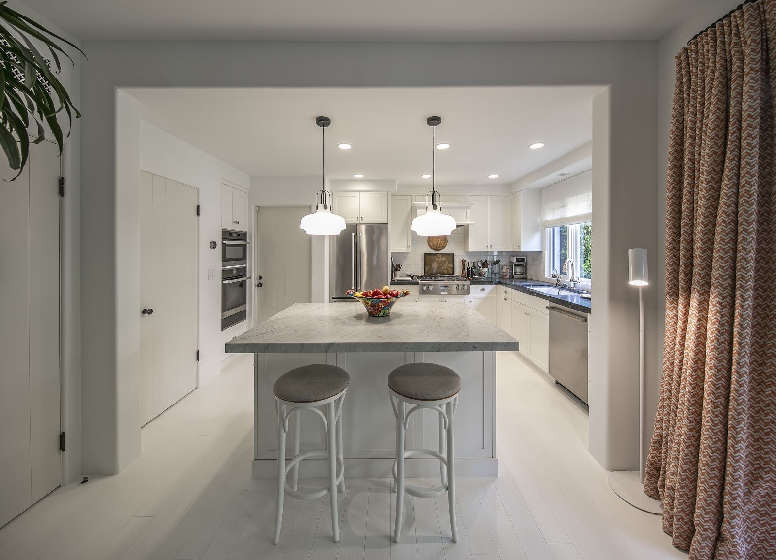 Quiet luxury, exemplified in a high-end kitchen that incorporates a mix of natural and warm ambient lighting.