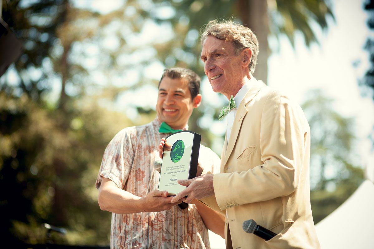 Bill Nye on stage with a presenter, getting an award in Santa Barbara