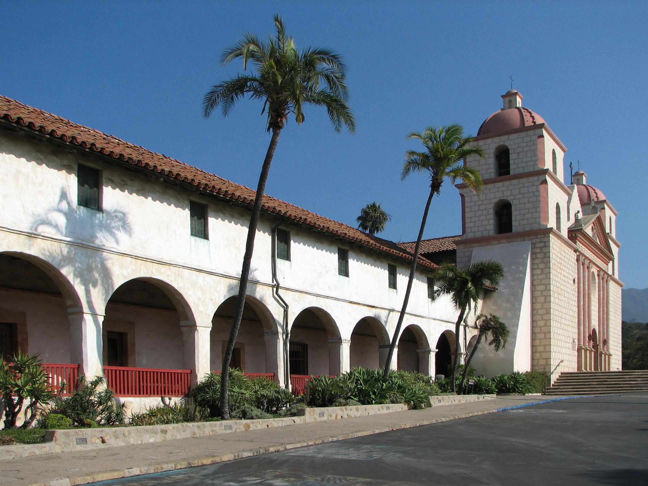 Adobe facade of the Old Mission in Santa Barbara, with blue sky