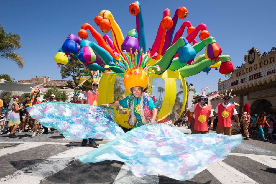 A man in a colorful balloon costume walking in the Santa Barbara Summer Solstice Parade.