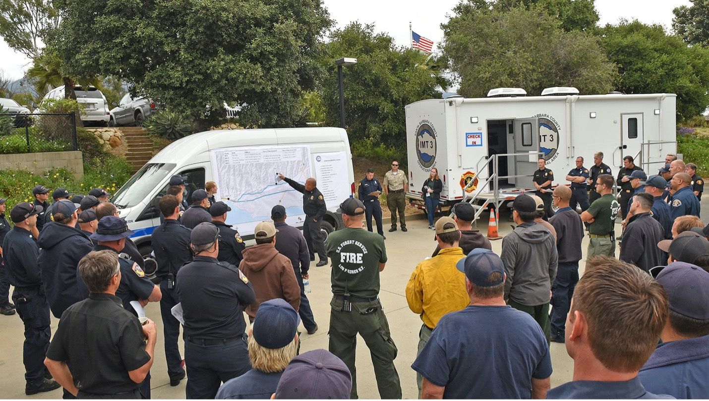 Santa Barbara Firefighters mobile command center with firefighters and the public surrounding vehicles