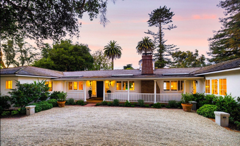 Large ranch-style Montecito home beyond a motor court.