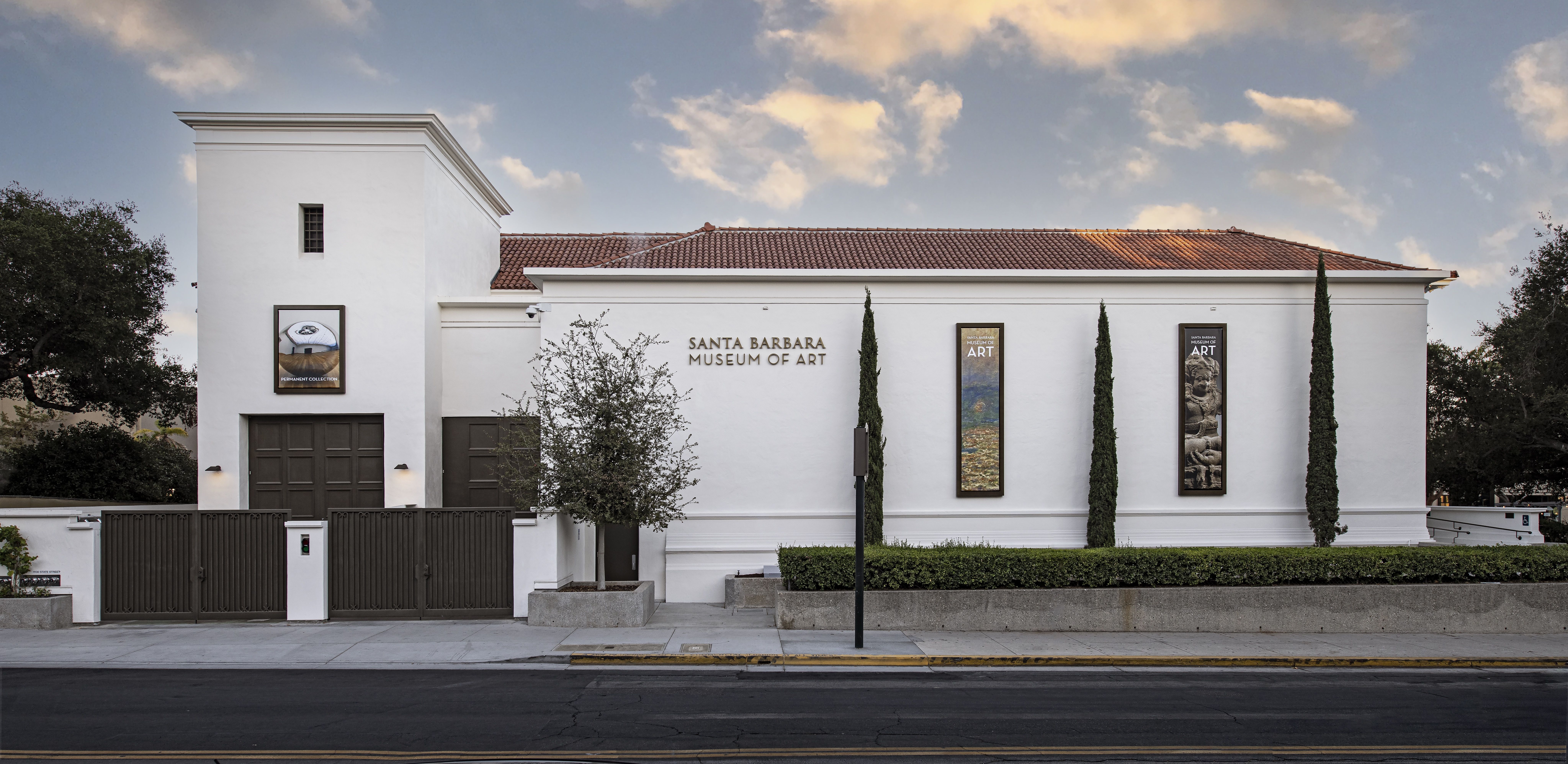 White facade of the Santa Barbara Museum of Art, with its red tile roof and blue sky.