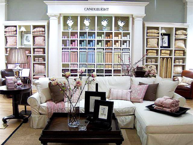 RH showrooms with comfy couch in front of displays of colorful merchandise